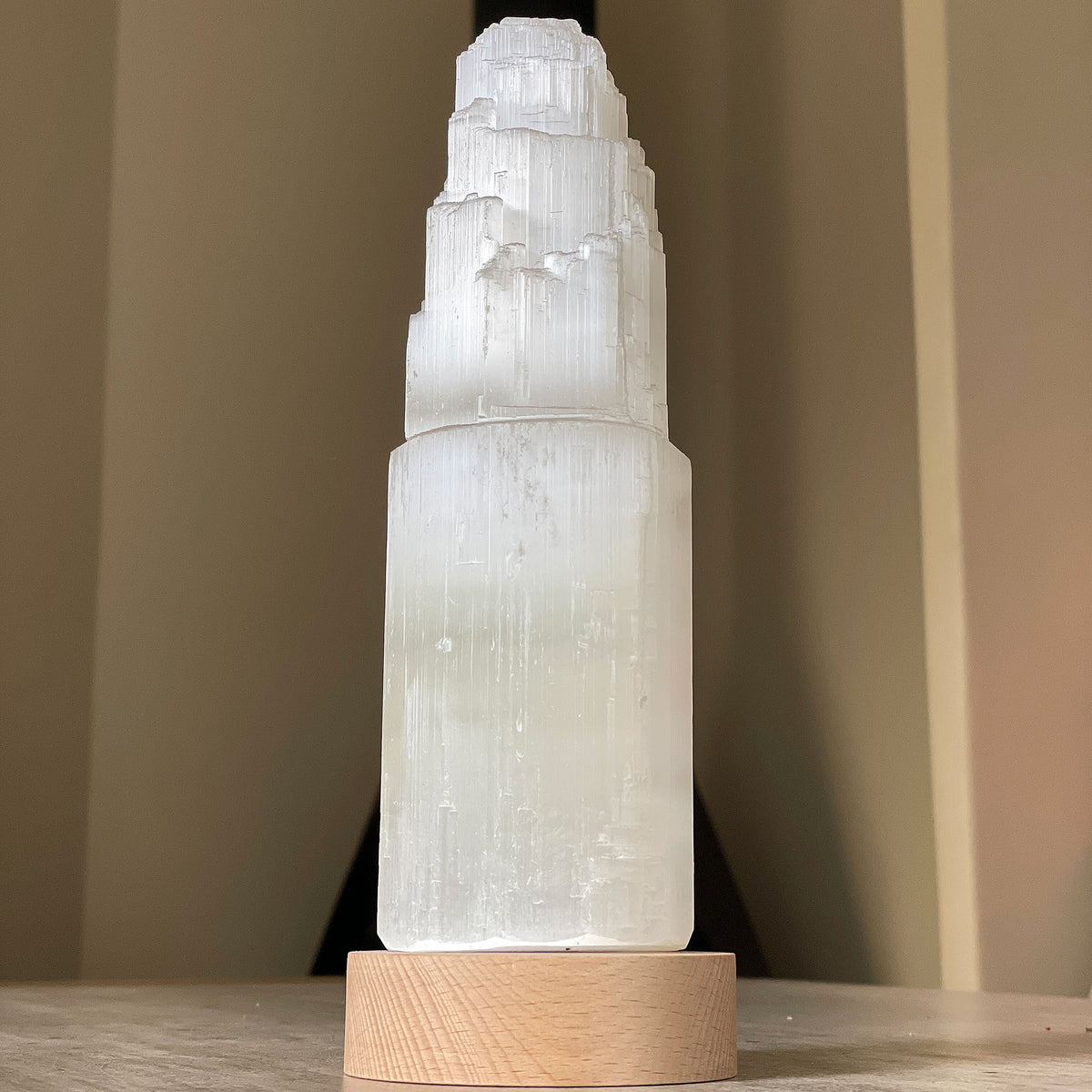Selenite Lamp - Tower Large - Selenite is a beautiful and versatile crystal that offers numerous benefits, making it a popular choice for both decor and holistic purposes. Its natural beauty and unique translucent appearance make it an eye-catching addition to any home. Selenite emits a soft and warm glow, which makes it an excellent choice for a night light.