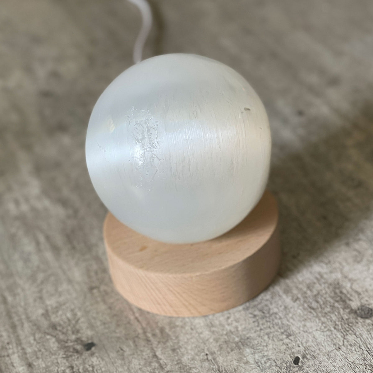 Selenite Lamp - Sphere - Selenite is a beautiful and versatile crystal that offers numerous benefits, making it a popular choice for both decor and holistic purposes. Its natural beauty and unique translucent appearance make it an eye-catching addition to any home.