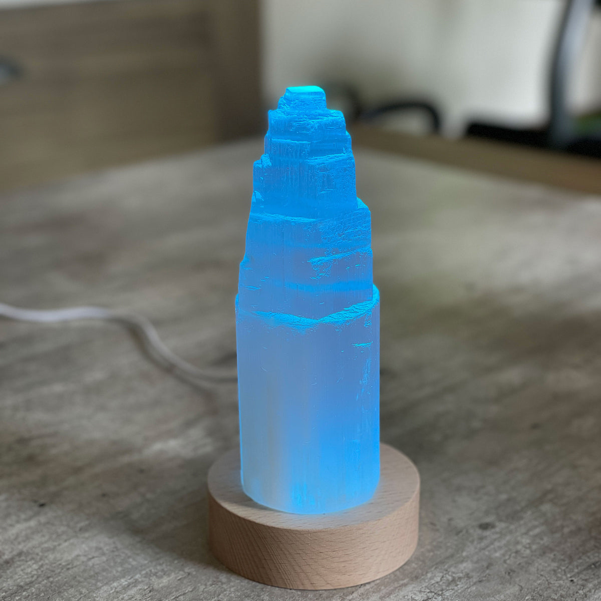 Selenite Lamp - Tower Small - Selenite is a beautiful and versatile crystal that offers numerous benefits, making it a popular choice for both decor and holistic purposes. Its natural beauty and unique translucent appearance make it an eye-catching addition to any home. Selenite emits a soft and warm glow, which makes it an excellent choice for a night light.