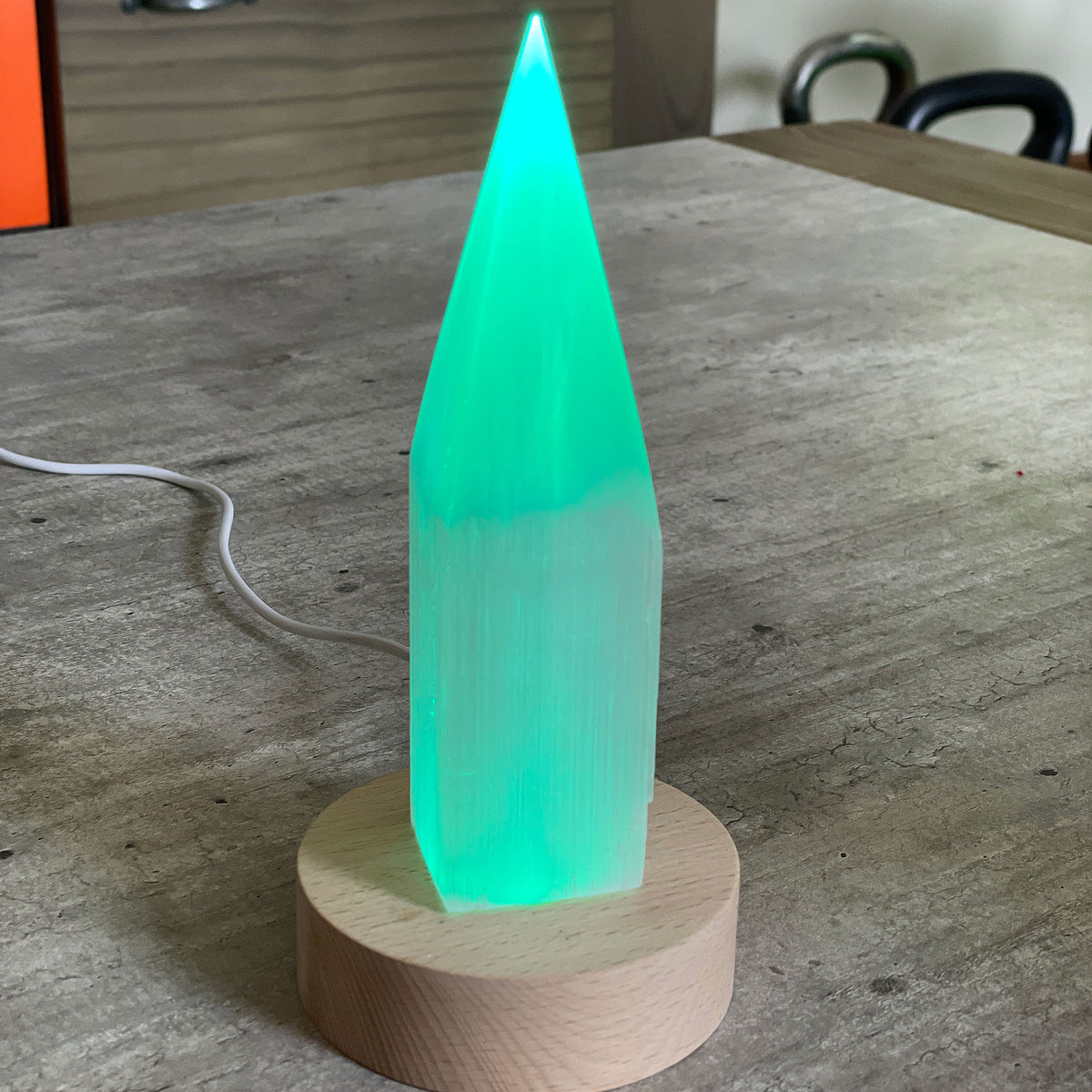 Selenite Lamp - Pencil Point Small - Selenite is a beautiful and versatile crystal that offers numerous benefits, making it a popular choice for both decor and holistic purposes. Its natural beauty and unique translucent appearance make it an eye-catching addition to any home. Selenite emits a soft and warm glow, which makes it an excellent choice for a night light.