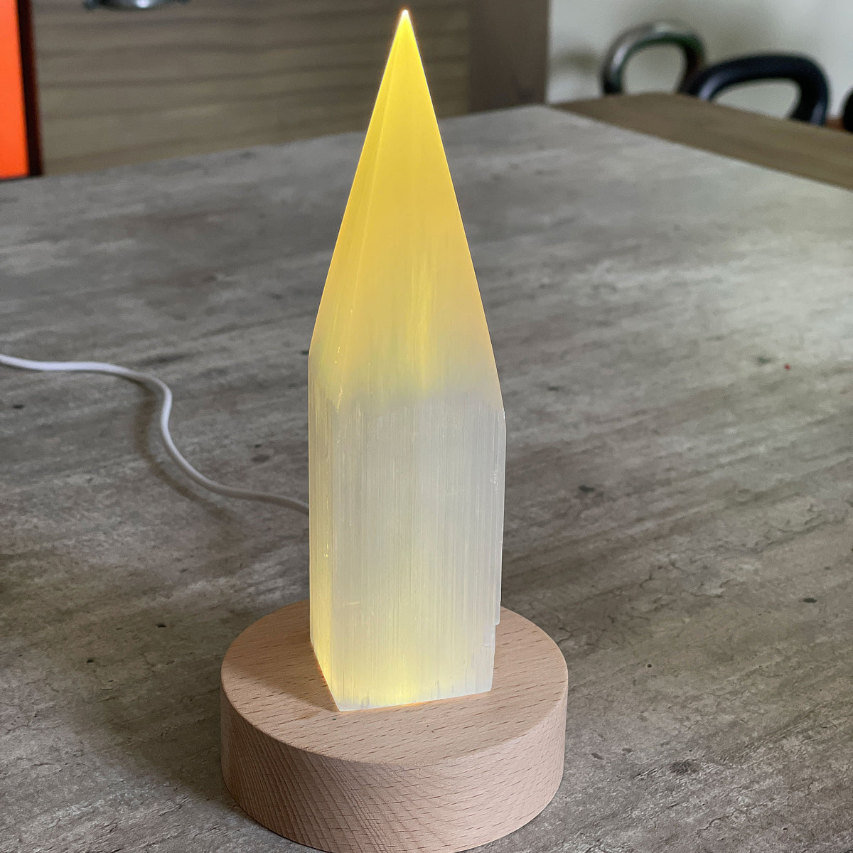 Selenite Lamp - Pencil Point Large - Selenite is a beautiful and versatile crystal that offers numerous benefits, making it a popular choice for both decor and holistic purposes. Its natural beauty and unique translucent appearance make it an eye-catching addition to any home. Selenite emits a soft and warm glow, which makes it an excellent choice for a night light.
