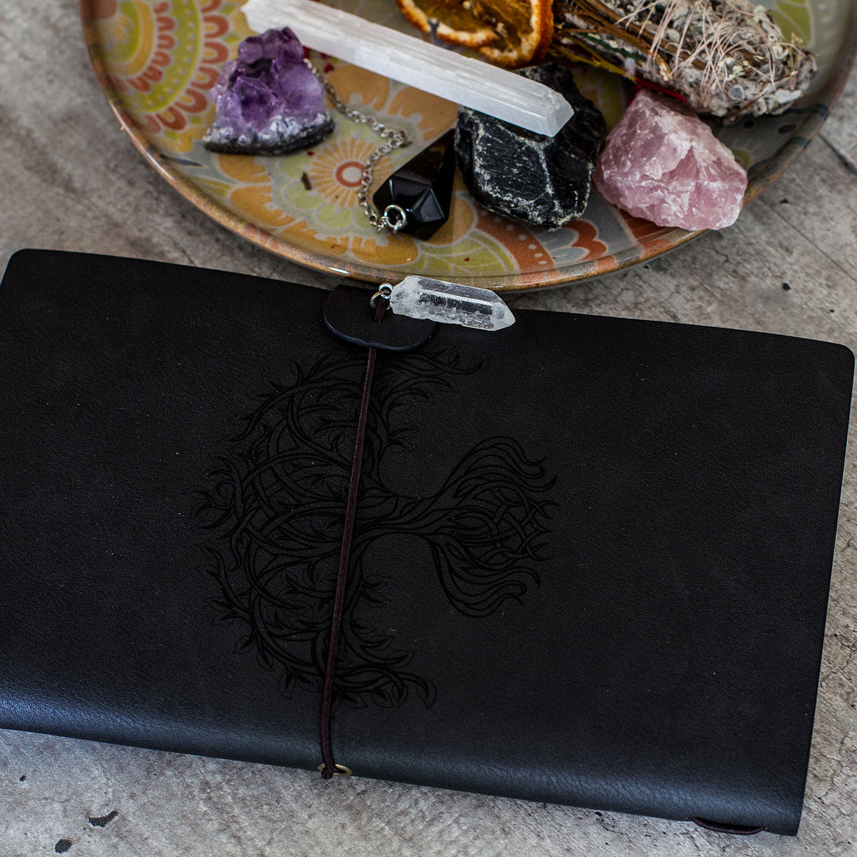 Manifestation Journal - Tree of Life (Black Leather) - Capture your thoughts and ambitions in this elegant leather journal complete with an elastic band and a hanging crystal to manifest your ideal life.