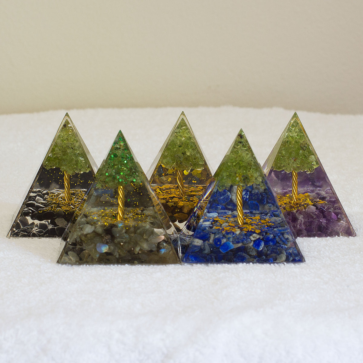 By tapping into the cosmic universal energy with a mix of quartz crystals, semi-precious gemstones, metals, and resin, you can balance out the life energy that surrounds you. Any negative vibes and energy that affect your body and mind can be removed by using an orgonite pyramid in your home. These healing crystals are made of metal shavings, resin, and gemstones, which balance electromagnetic fields and promote positive energy.