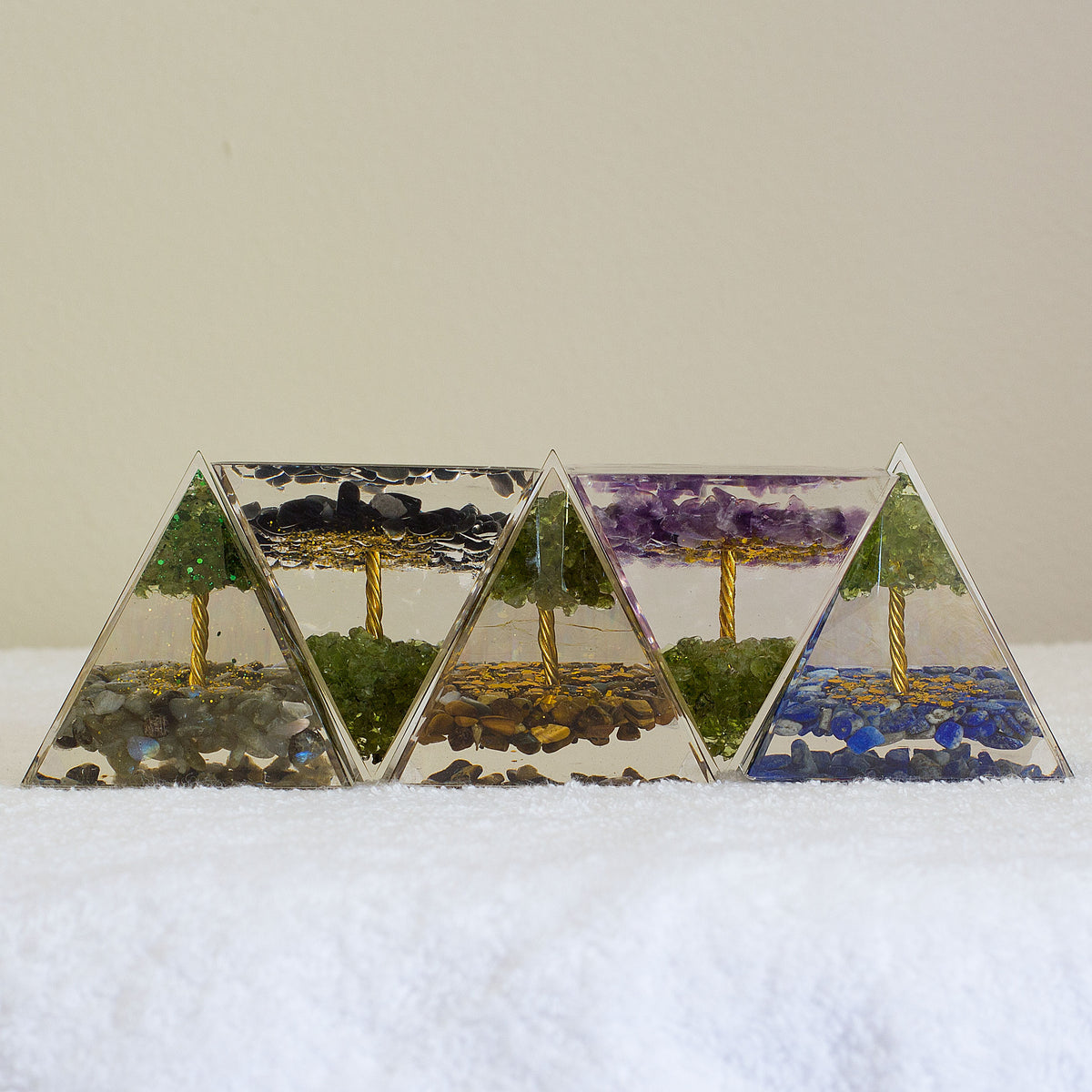 By tapping into the cosmic universal energy with a mix of quartz crystals, semi-precious gemstones, metals, and resin, you can balance out the life energy that surrounds you. Any negative vibes and energy that affect your body and mind can be removed by using an orgonite pyramid in your home. These healing crystals are made of metal shavings, resin, and gemstones, which balance electromagnetic fields and promote positive energy.